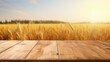 Empty wooden table top with a background of golden rice fields nearing harvest. bright morning light Templates for displaying products