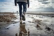 man walking in rubber boots in the Wadden Sea