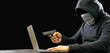 Portrait hacker spy man one person in black hoodie sitting on table looking computer laptop used password attack security intimidate to circulate data digital  internet network system dark background