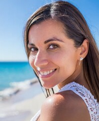 Wall Mural - Beautiful Woman Smiling On The Beach