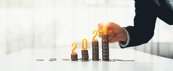 Growth coin stack symbolizing business investment and economic growth. Business people doing financial planning to achieve financial goal and contribute maximum profit on new year 2024 . Shrewd