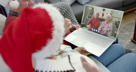 Poster - Two happy caucasian senior couples having christmas laptop video call, slow motion