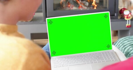 Canvas Print - Happy caucasian male friends having christmas laptop video call, green screen, slow motion