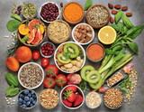 Fototapeta Kuchnia - food for fitness concept with fruit, vegetables, pulses, herbs, spices, nuts, grains and pulses. High in anthocyanins, antioxidants, smart carbohydrates, omega 3, minerals and vitamins