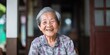 Chinese granny sitting on a chair in the house with a kind smile, generative AI