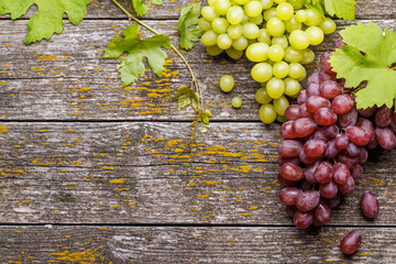 Wall Mural - Grape with vine leaves on wooden table