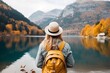 Generative AI : tourist woman with a big yellow backpack enjoys the view of the mountain lake