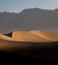 Lone Man On A Sand Dune In Death Valley, California, USA.