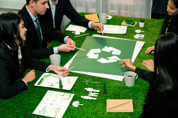 Recycle icon on meeting table in office with business people planning eco business investment on waste management as recycle reduce reuse concept for clean ecosystem. Quaint