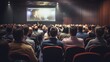 © GulArt - Back view of an audience in a conference hall listening to a seminar with big cinema screen
