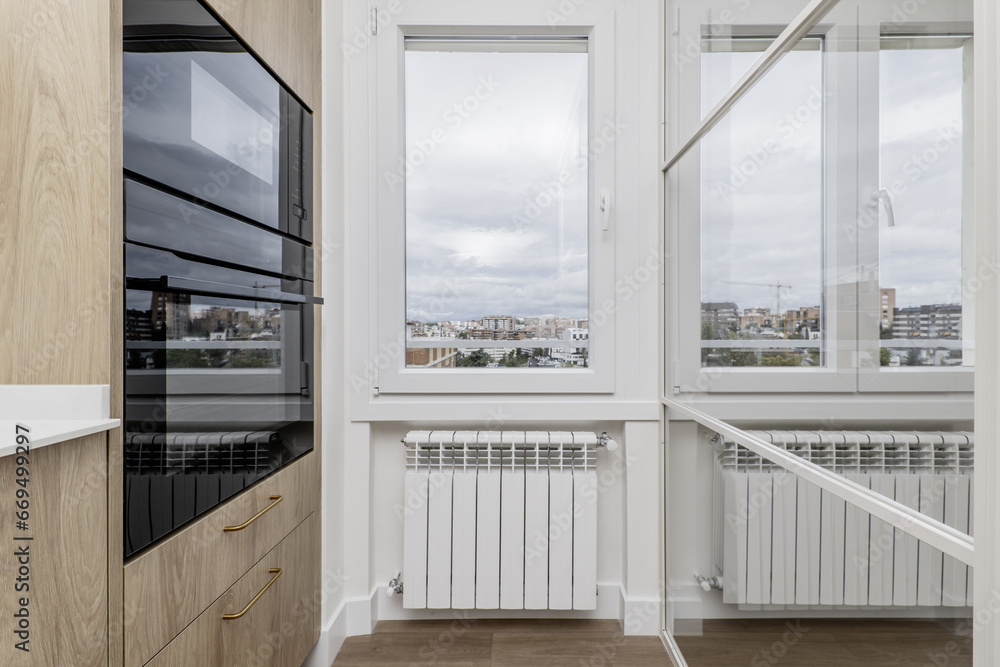 Corner of a newly installed kitchen with white stone countertop and ...