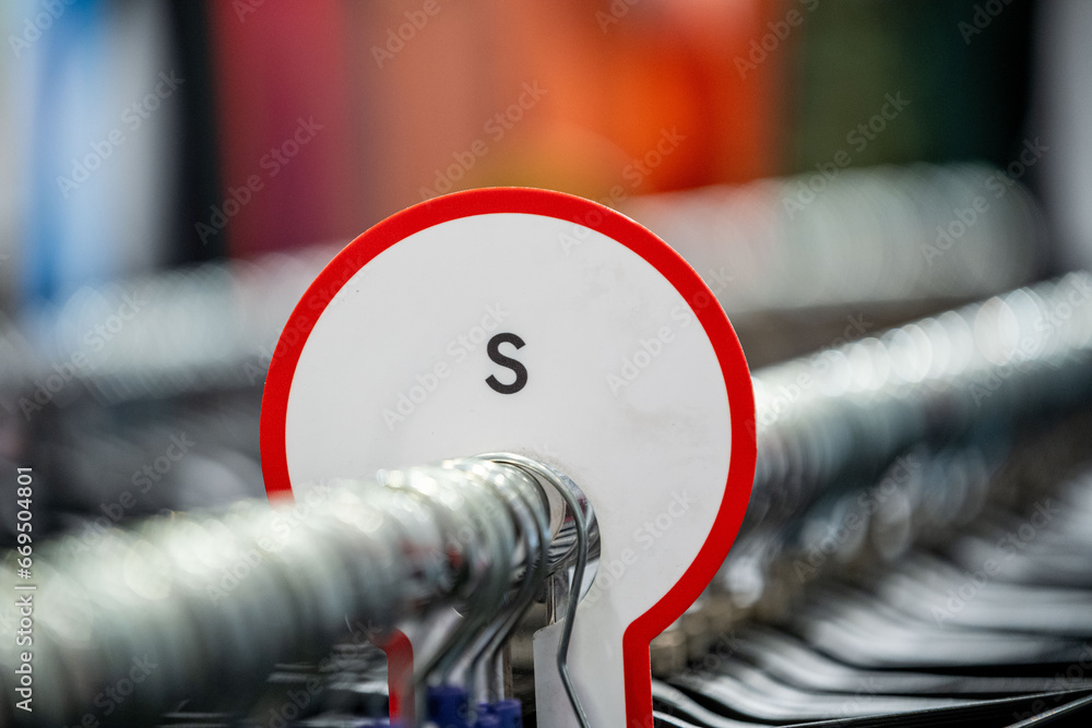 Size marking of the clothes on the clothes rack Stock Photo | Adobe Stock