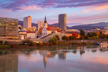 Wall Mural - Linz, Austria. Cityscape image of riverside Linz, Austria at beautiful autumn sunrise with reflection of the city in Danube River.