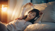 © Dirk - copy space, stockphoto, Female chinese college student using phone and headphones listening to music lying on bed in a student dorm. Student life. Relaxing female Chinese student.
