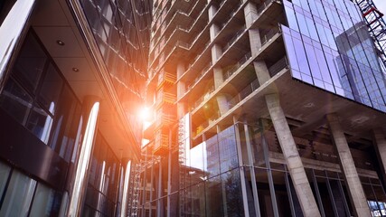 Wall Mural - View of a skyscraper under construction. Modern architecture background. Building a high-rise building,  the concept of real estate construction. 