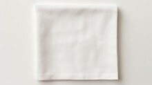 Top View With White Empty Kitchen Napkin Isolated On Table Background. Folded Cloth For Mockup With Copy Space, Flat Lay. Minimal Style.