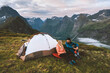 © EVERST - Couple friends traveling together with camping tent gear romantic vacations man and woman hiking adventure outdoor family healthy lifestyle explore mountains of Norway