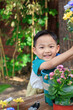 © View Stock - The happy little boy pruned the flowers and plants