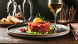 Tuna tartare on a restaurant table with a glass of wine, commercial banner