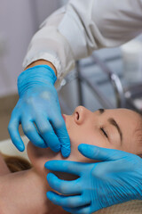 Woman receiving facial buccal massage in beauty salon.Beauty and skincare concept with a beautiful woman. Middle aged female relaxed with massage for facial lifting