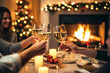 © colnihko - Happy friends having fun and toasting sparkling wine glasses close-up against burning fireplace background. Christmas celebration