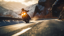 Motorcyclist rides on a motorbike on the mountain road in winter