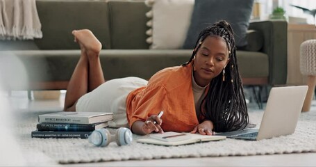 Canvas Print - Laptop, laying and woman writing notes on the floor in the living room of modern apartment. Technology, research and young African female university student studying on a computer in lounge at home.