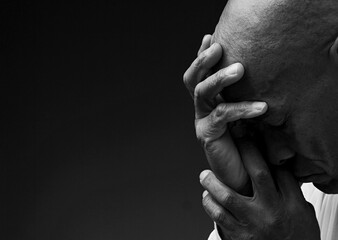 Wall Mural - man praying to God with the bible on black background with people stock image stock photo