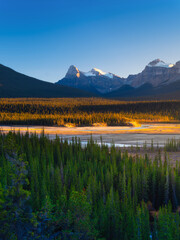 Wall Mural - mountain landscape at dawn. sunbeams in a valley. rivers and forest in a mountain valley at dawn. na