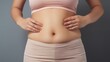 © Pro Hi-Res - Close up woman touching her stomach. Fat, lose weight concept.