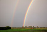 Fototapeta Tęcza - Rural landscape with double rainbow and beautiful sky colors after rain in the Netherlands in early autumn