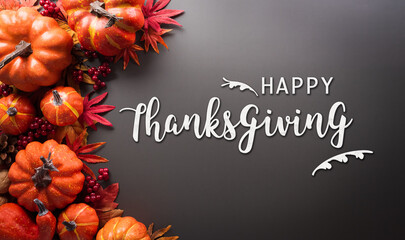 Wall Mural - thanksgiving and autumn decoration concept made from autumn leaves, pumpkin and the text on dark bac
