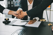 © ARMMY PICCA - Businessman shaking hands to seal a deal with his partner lawyers or attorneys discussing a contract agreement