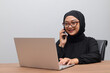 © Yazid Nasuha - Portrait of attractive Asian hijab woman working on her laptop. Muslim girl making a phone call in office. Employee and freelance worker concept.
