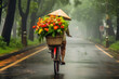 Vietnamese woman in conical hat selling flowers in rain. ,