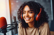 © VisualProduction - Beautiful african american young woman talking and smiling in studio at podcast recording, woman hosting online radio event,