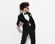 © Viorel Sima - cool fashion businessman in black tux looking to side and moving