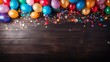Colorful party frame with balloons, streamers and confetti on rustic wood background