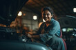 © Niks Ads - Young female car mechanic working at garage