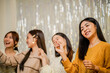 © Charlie's - Cheerful friends enjoying home Birthday holiday party. Asian Friends hold lights with sparkling Sparkler celebrating Christmas or New Year eve party.