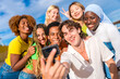 © unai - Multi-ethnic friends taking a selfie with a gopro