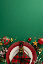 Get Ready For A New Year's Soirée! Vertical Top View Captures Plates, Gold Cutlery, Checkered Napkin, Baubles, Star Candle, Confetti, Frosty Fir Twigs, Mistletoe, And A Green Backdrop For Your Text