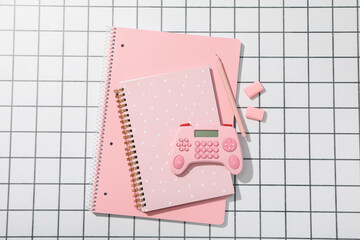 Notepads, calculator and pen on light background, top view