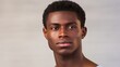 © ALA - Portrait of a handsome elegant sexy African man with dark and perfect skin, on a gray beige background.