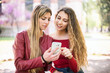 © Minerva Studio - Smiling women using a cell phone