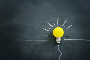 Wall Mural - Education concept image. Creative idea and innovation. light bulb metaphor over blackboard background