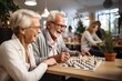 © Atlas Studio - A group of old people pensioners play board games for the development of intelligence and spend interesting time in a house for the elderly.