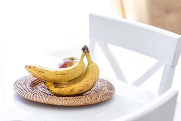 Sticker - A bunch of ripe bananas in a bright kitchen interior.