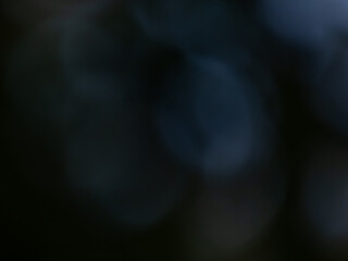 Wall Mural - Black and dark blue bokeh effect and purposely blurred view. Dark background with photographic bokeh effect