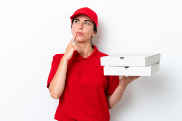 Wall Mural - Pizza delivery caucasian woman with work uniform picking up pizza boxes isolated on white background having doubts while looking up